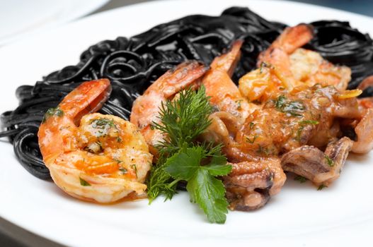 fried shrimps with exotic black spaghetti tinted by cuttlefish ink