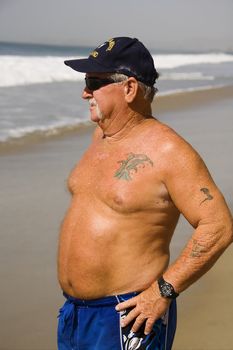 Senior Man looking out at the Ocean enjoying the Beach.