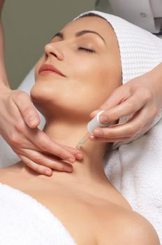 applying of anti-wrinkles treatment for neck skin in the beauty salon