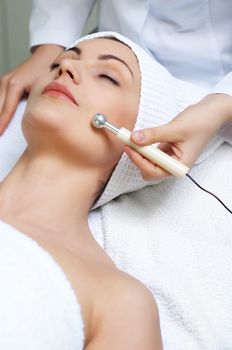 young pretty woman getting special skin treatment at beauty salon
