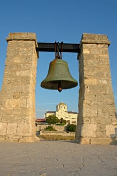 The big bell on a background of the Cathedral in Chersonese near Sevastopol                               