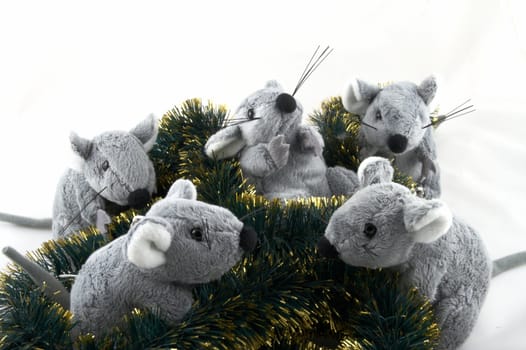 The grey toy mouse sitting in a tinsel