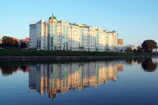 The high-rise building on bank on a sunset