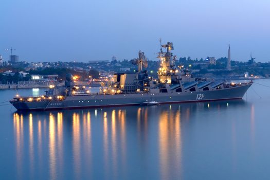 The battleship leaves on night watch in the sea                               