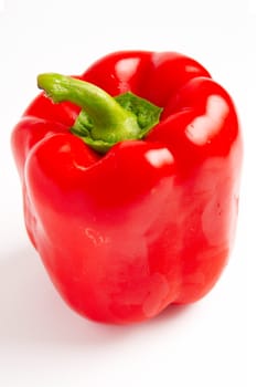 Red sweet pepper with a green cutting on a white background