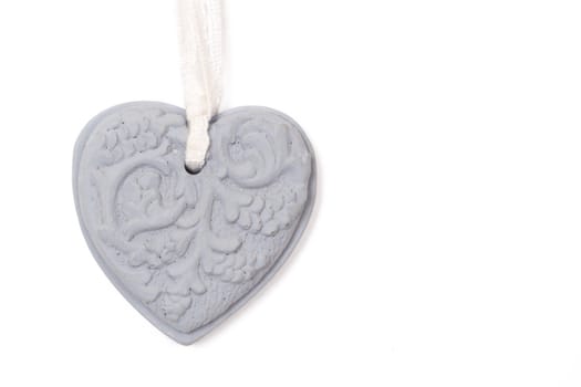 Grey stone heart with patterns on white background