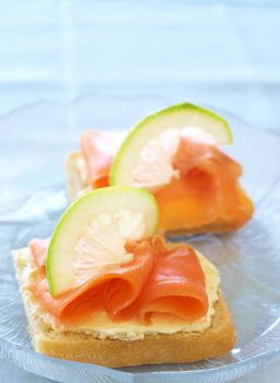 Smoked salmon and cream cheese on white bread with slice of lemon 