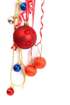 Colorful Christmas baubles hanging on a string on white background with copy space. 