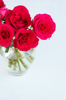 Bunch of pink roses in a vase on light background