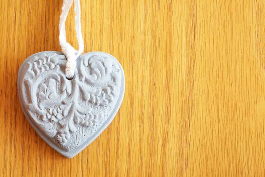 Handmade stone heart shape on wooden background