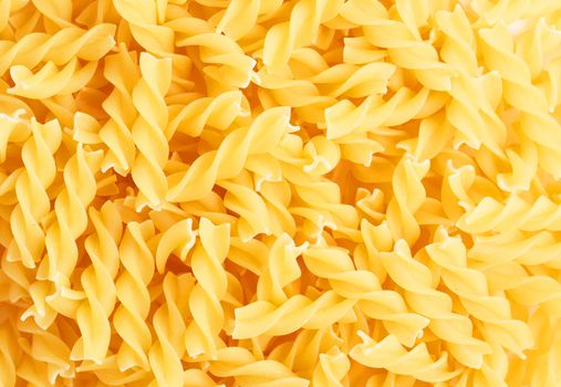 Closeup of Fusilli swirl pasta forming a background