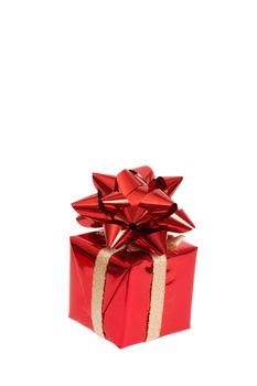 Red gift box with a bow for Christmas or Valentines Day isolated on white background with copy space