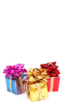 Three colorful gift boxes with bows for Christmas or Valentines Day isolated on white background with copy space