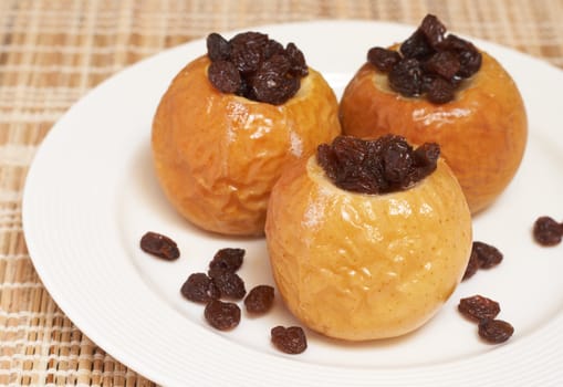 Delicious dessert of freshly baked organic apples with raisins