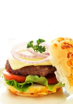 Tasty hamburger with grilled patty, tomato, cheese and lettuce on white background