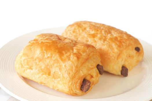 Chocolate filled croissants on white plate