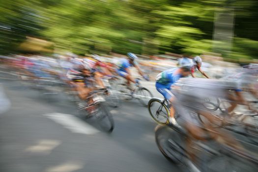 The cyclists riding by at the bicycle race Around Denmark