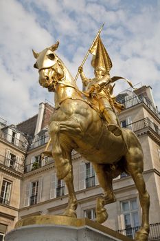The golden statue of Saint Joan of Arc with the nickname The Maid of Orleans in Rue Rivoli - Paris, France. She is considered as a heroine of France and a Catholic saint.