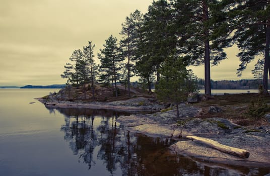 Retro tranquillity by a Swedish lake at summertime. Cross processed.