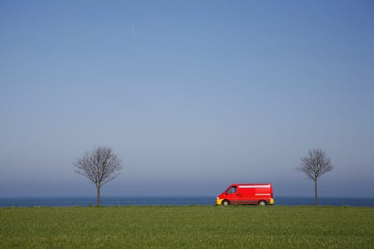 Van driving along a coastal highway - Denmark - at springtime. Motion blur.