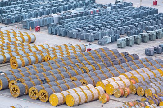 electricity cable on wooden spools and many transformer on the floor