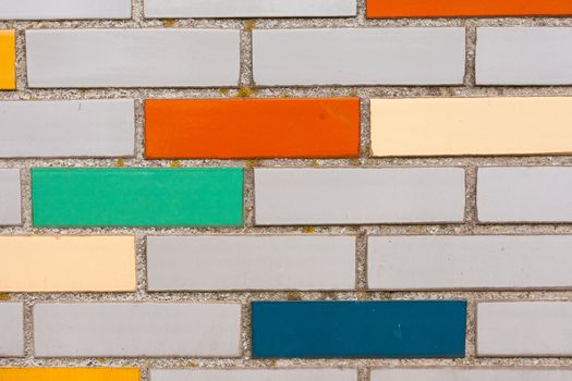 Background texture pattern of exterior wall with fake colorful brick siding.