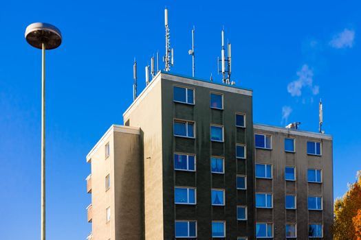 Apartment house with cellular antennas on roof for cellphone service.