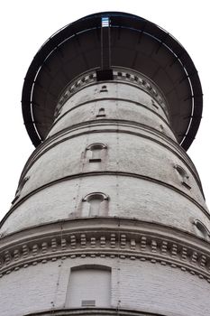 Historic water reservoir brick tower landmark still in use (isolated on white).