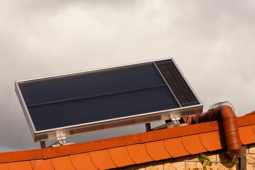 Roof-mounted solar hot water heater collects heat from sun.