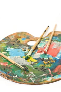 artist's palette with colorful paint and brushes.