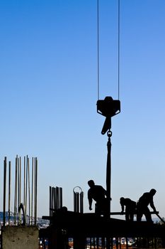 Construction workers front of blue sky