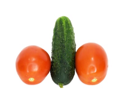 two tomatoes were insulated and one cucumber on white