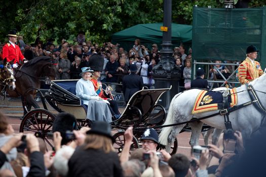 LONDON - JUNE 11: The Queen Elizabeth II and The Duke of Edinburgh leaves Trooping the Color ceremony trough streets crowded of spectators in London, England on June 11, 2011. Ceremony is performed by regiments on the occasion of the Queen's Official Birthday