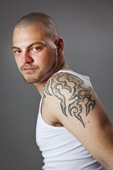 An image of a handsome man with tattoos