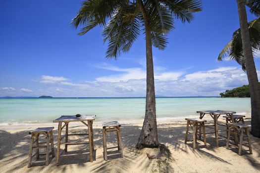 Bamboo table and chairs on a beautiful beach in thailand. Ko phi phi island.