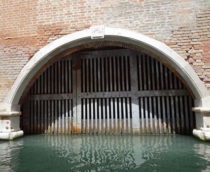 venetian old door on a canal