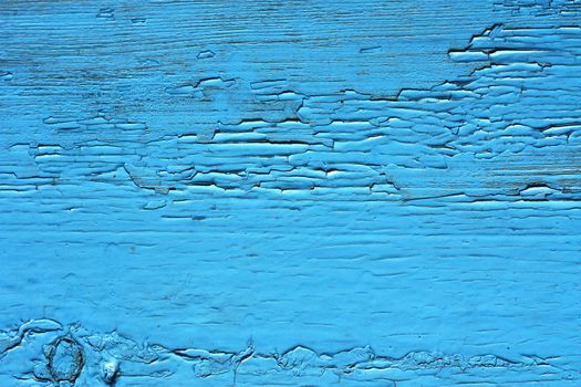 Closing on blue wooden panels of the fence 