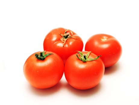 four full tomatoes with water drops isolated on white background 



