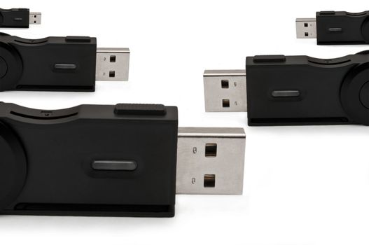 Close and low level capturing several usb sd adaptors arranged over white