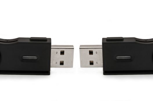 Close and low level capturing two usb sd adaptors arranged over white