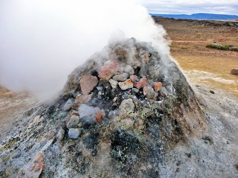 Rock pile geothermal fumarole in iceland in summer time