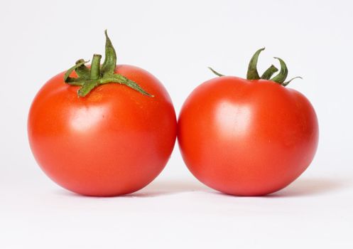 Two tomatoes isolated on white background 