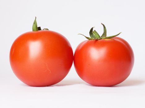 Two tomatoes isolated on white background 