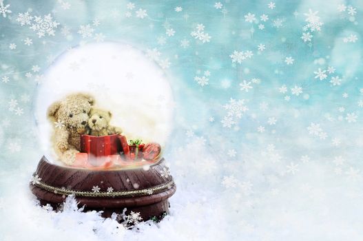 Two adorable little teddies inside of a snow globe against a blue background.