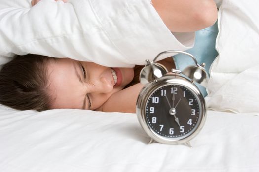 Sleeping woman waking alarm clock