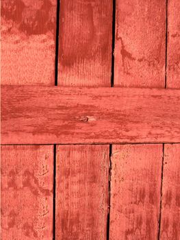 Closing on red wooden panels of the fence     