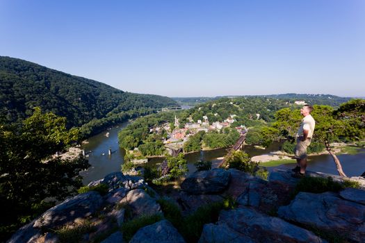 Senior male hiker overlooking the shenandoah and potomac rivers by the town of Harpers Ferry