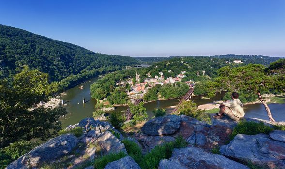 Senior male hiker overlooking the shenandoah and potomac rivers by the town of Harpers Ferry