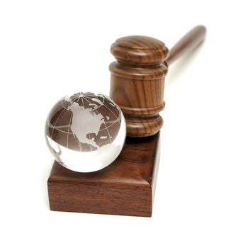 A globe rests near a gavel for worldly concepts like global auctions and world order.