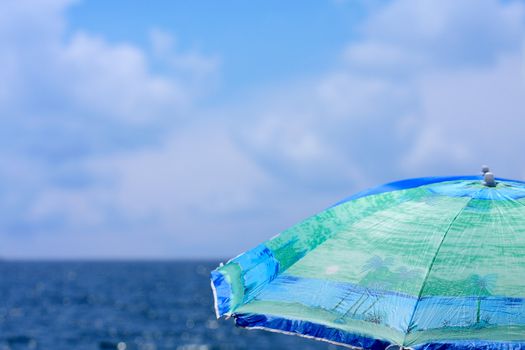 Beach umbrella close up against a sea landscape